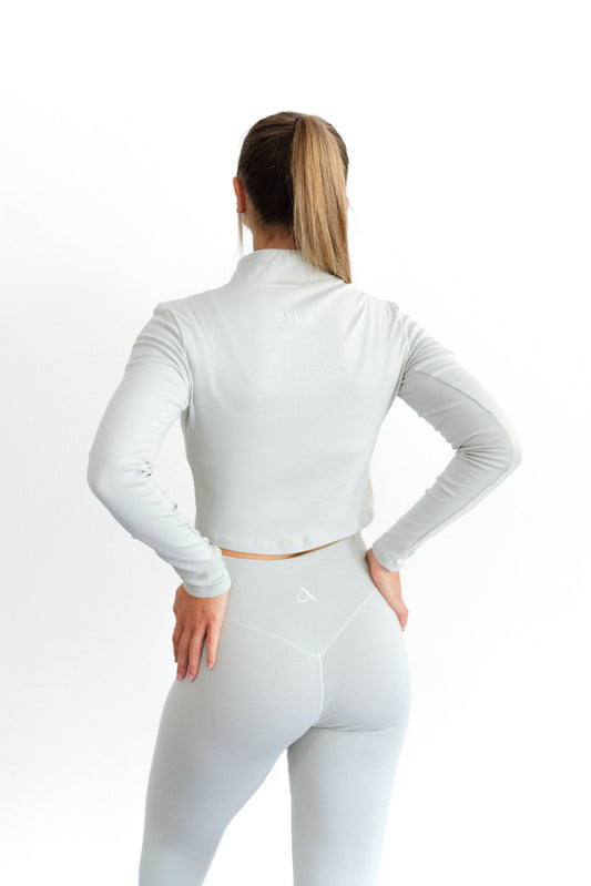 Back detail of the sage SYLA Sculpt Jacket and high-waist Sculpt Legging with centre seam