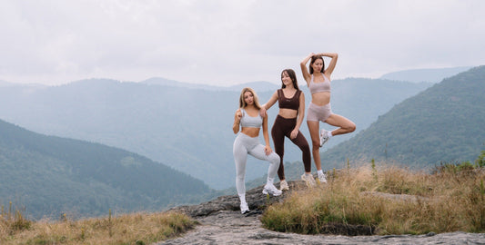 Three women in SYLA organic cotton activewear on a mountain overlook