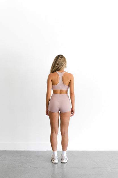 Full back view of the blush SYLA Racer Set, racerback top and seamless high-waist short