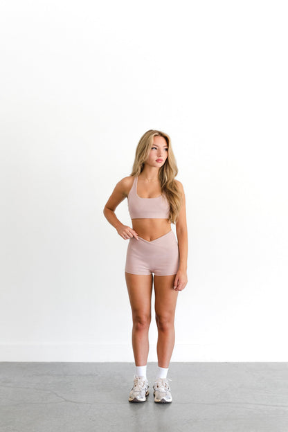 Front view of the blush SYLA Racer Top, scoop neckline shown with matching short