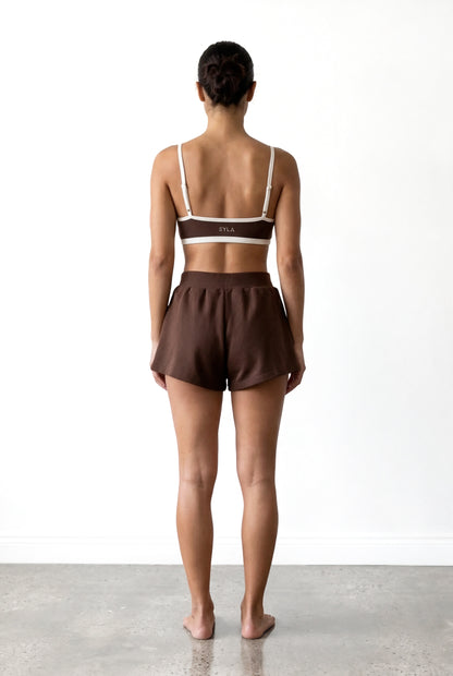 Back view of the SYLA Sauna Set in espresso showing the logo waistband and open back