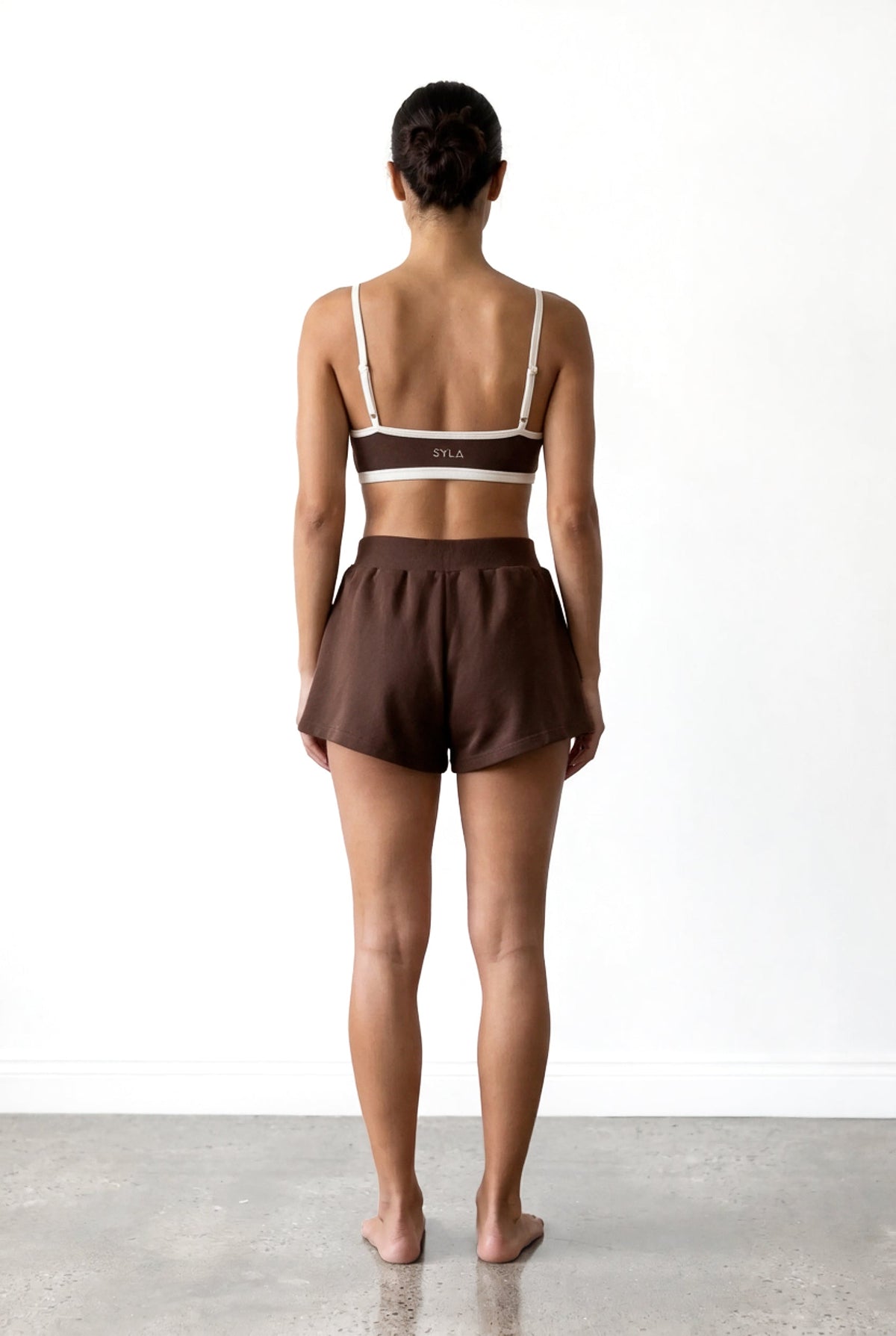 SYLA Sauna Top in espresso, back view showing the logo band