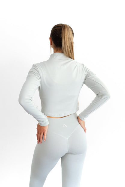 Back detail of the sage SYLA Sculpt Jacket and high-waist Sculpt Legging with centre seam
