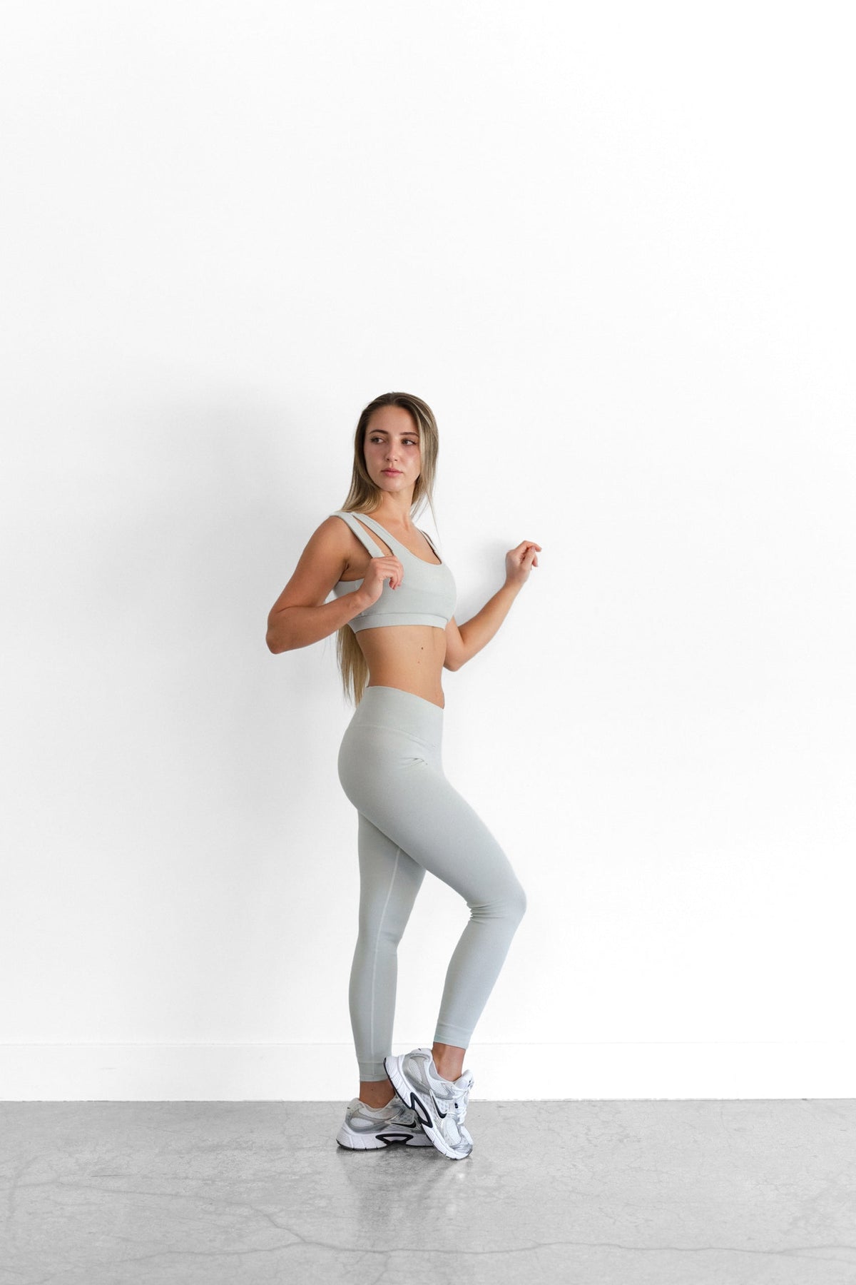 Side view of the sage SYLA Sculpt Set, showing the seam lines of the high-waist Sculpt Legging